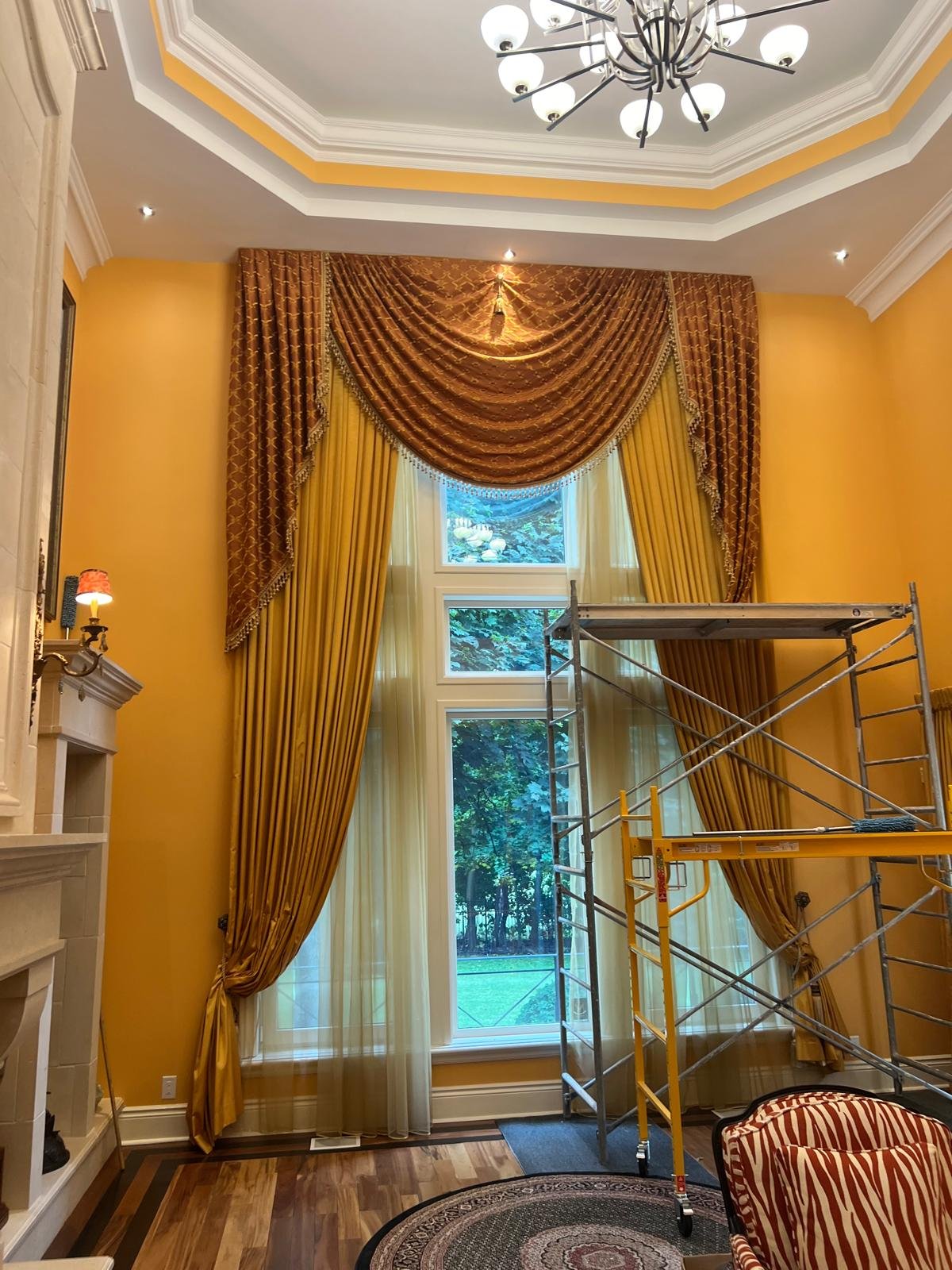 Toronto gold custom drapery installation for a feature window